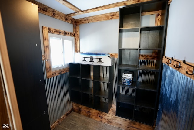 interior space with wood-type flooring and beam ceiling