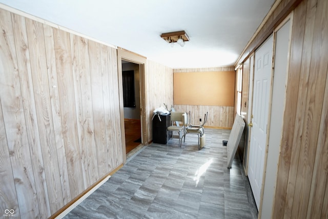 hall featuring wood walls