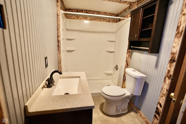 bathroom featuring toilet, walk in shower, and vanity