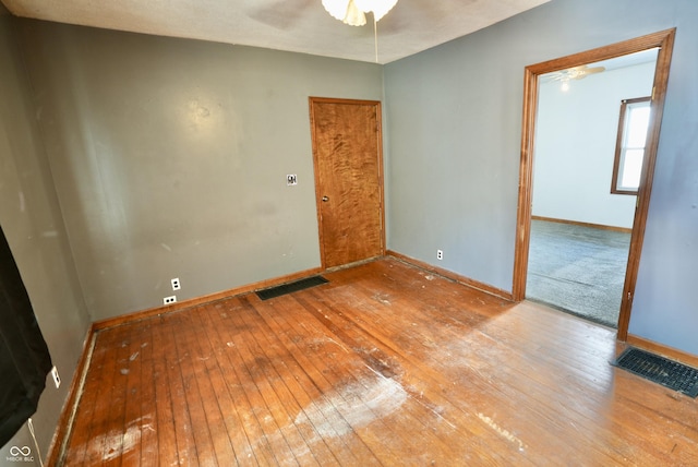 empty room featuring ceiling fan and light hardwood / wood-style flooring