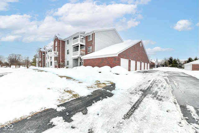 view of snowy exterior with a garage