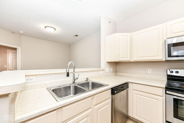 kitchen featuring kitchen peninsula, appliances with stainless steel finishes, and sink