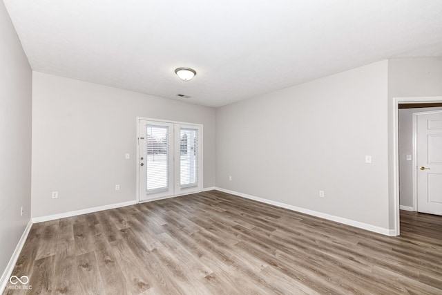 spare room with wood-type flooring