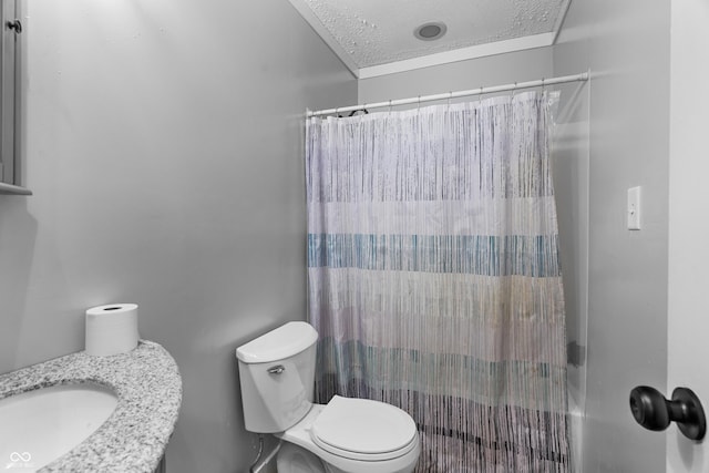 bathroom with sink, toilet, and a textured ceiling