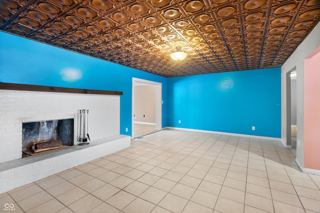 unfurnished living room with tile patterned floors and a brick fireplace