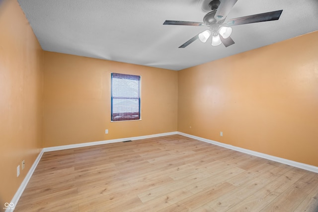 spare room with ceiling fan and light hardwood / wood-style floors