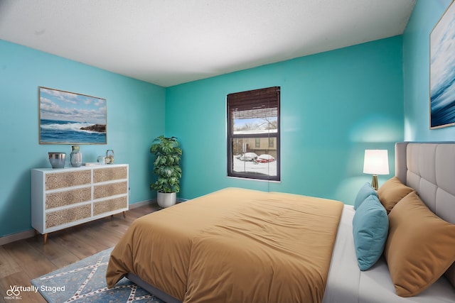 bedroom with hardwood / wood-style flooring