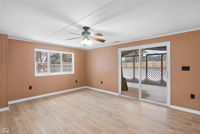 unfurnished room with ceiling fan, a wealth of natural light, and light hardwood / wood-style flooring