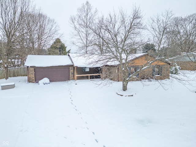 yard covered in snow featuring a garage