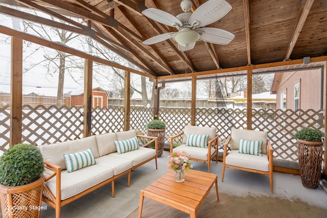 sunroom / solarium with ceiling fan and lofted ceiling