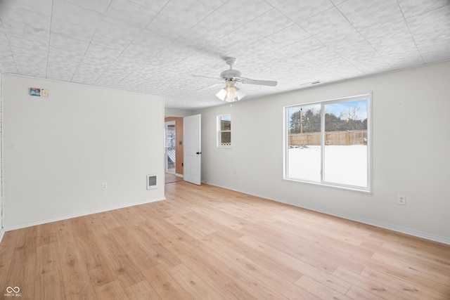 spare room with ceiling fan and light wood-type flooring