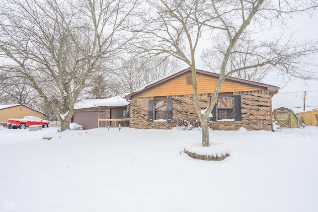 view of front of home with a storage shed