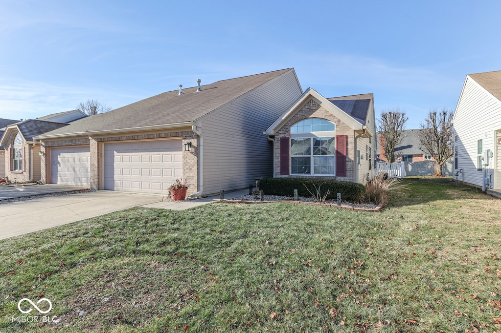 view of front facade with a garage and a front lawn