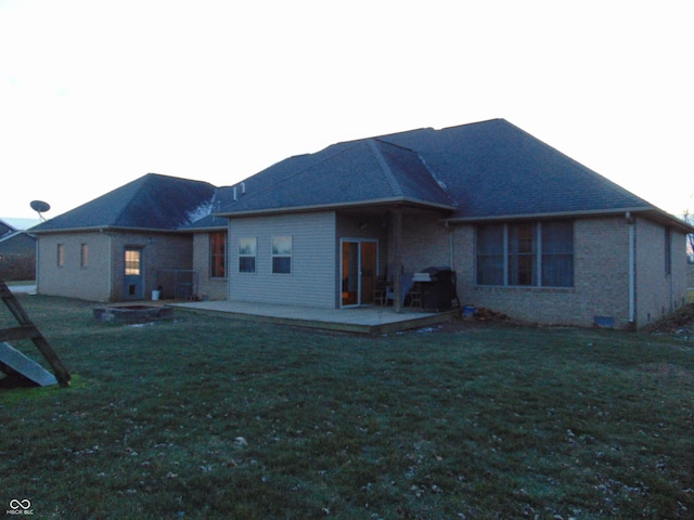 back of house featuring a patio and a lawn