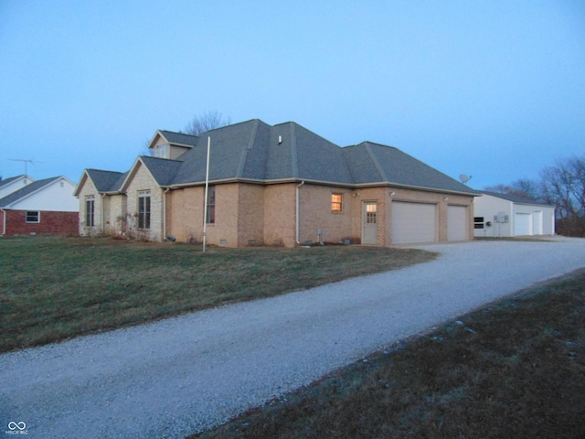 view of side of property featuring a yard and a garage