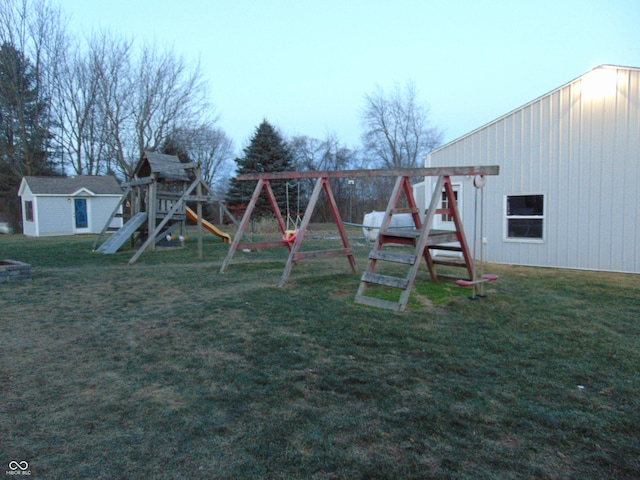 view of jungle gym with a lawn and a storage unit