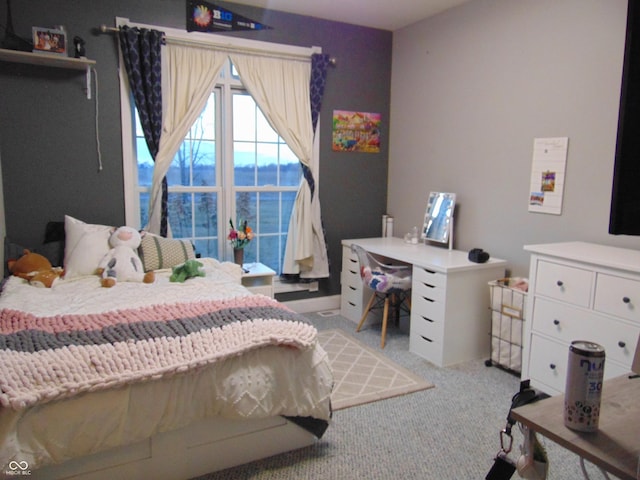 bedroom with light carpet and a water view