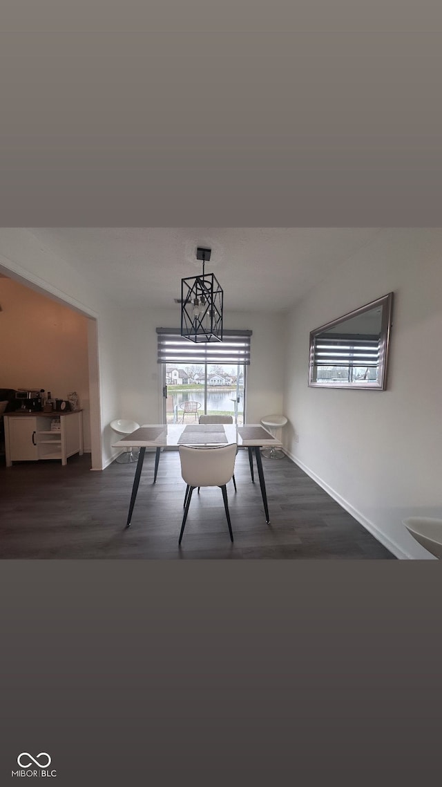 unfurnished dining area featuring dark hardwood / wood-style flooring