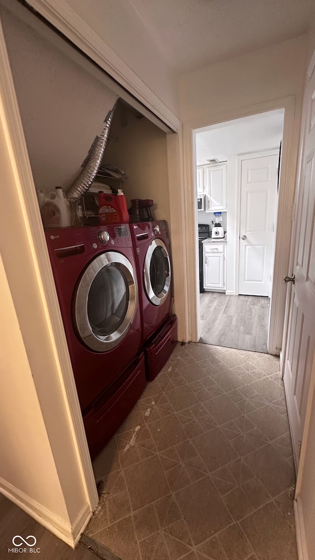 clothes washing area featuring separate washer and dryer