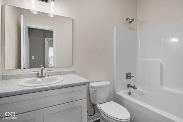 bathroom featuring shower / washtub combination, vanity, and toilet