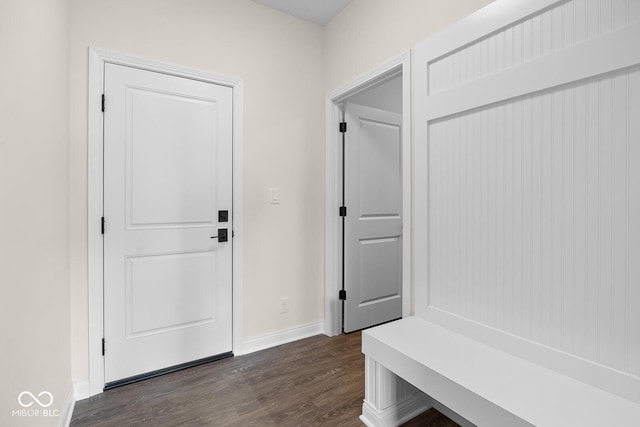 mudroom featuring dark wood-style flooring and baseboards