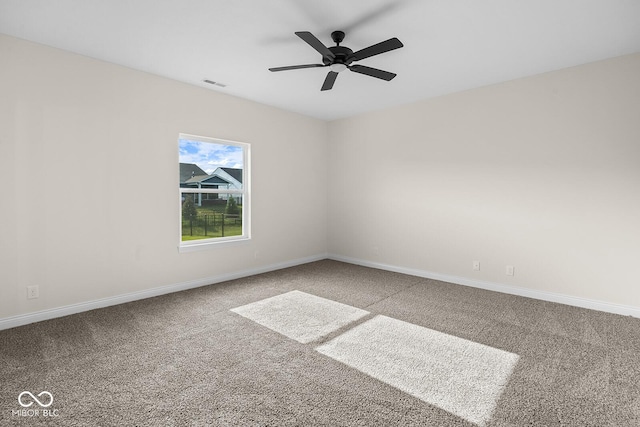 unfurnished room featuring ceiling fan, carpet flooring, visible vents, and baseboards