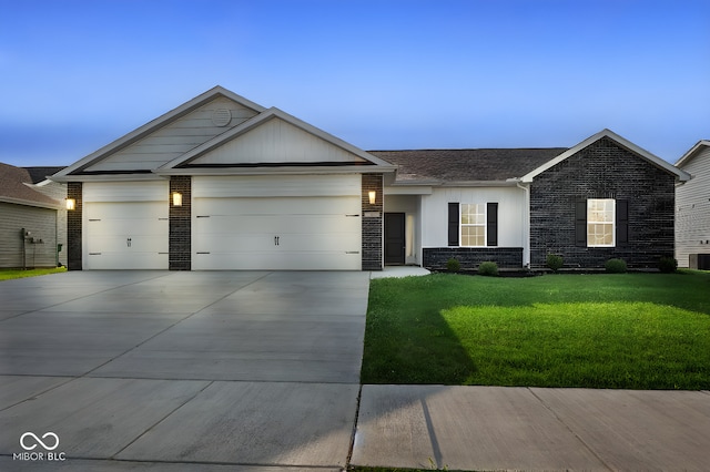 ranch-style home with an attached garage, central air condition unit, brick siding, concrete driveway, and a front lawn