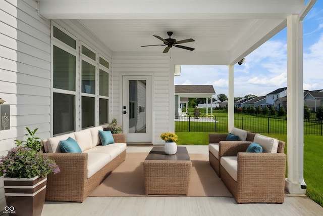 view of patio / terrace featuring fence, an outdoor living space, and a ceiling fan