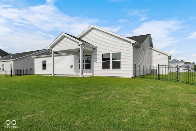 rear view of property with a lawn, a fenced backyard, and a ceiling fan