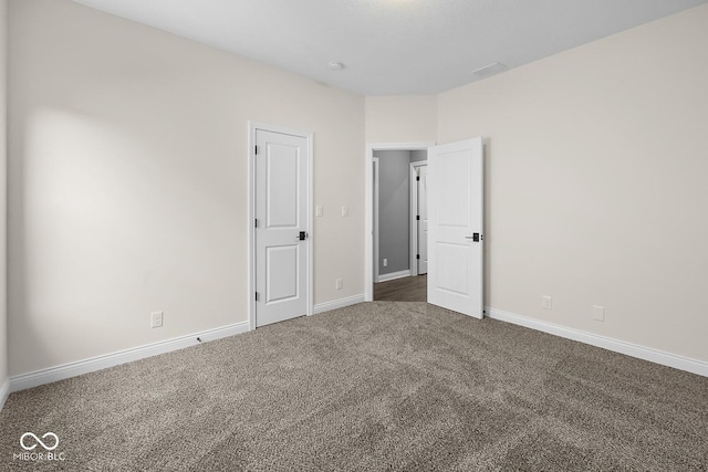 unfurnished bedroom with carpet and baseboards