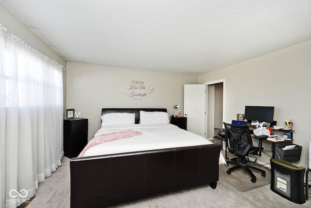 carpeted bedroom featuring a textured ceiling