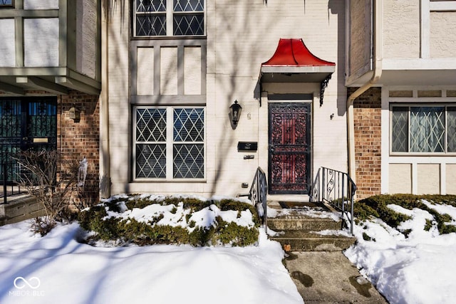 view of snow covered property entrance