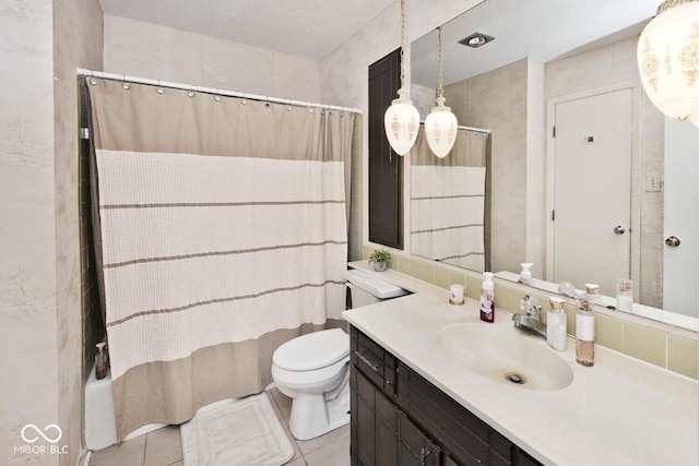 full bathroom featuring tile patterned floors, toilet, vanity, and shower / tub combo