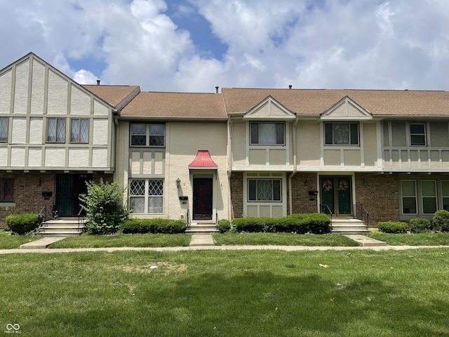 8021 E 20th St, Indianapolis, IN 46219 - view of front facade with brick siding and a front yard