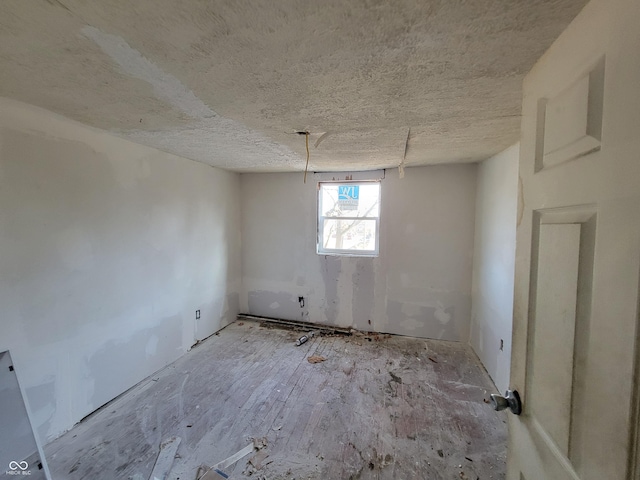 spare room featuring a textured ceiling