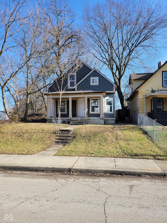 view of front of house with covered porch and a front lawn