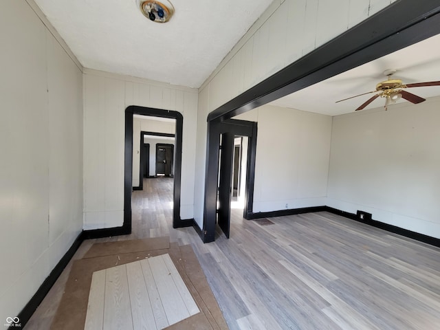 spare room featuring ceiling fan and light hardwood / wood-style flooring