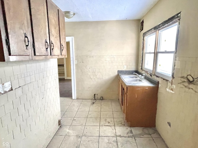 kitchen featuring sink and light tile patterned flooring