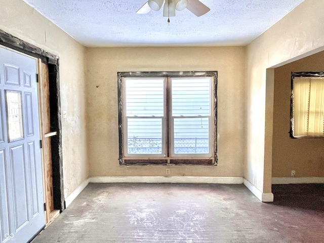 spare room with ceiling fan and a textured ceiling