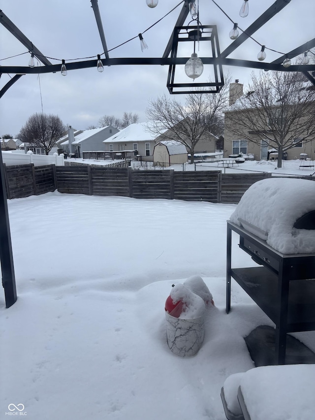 yard covered in snow featuring basketball court