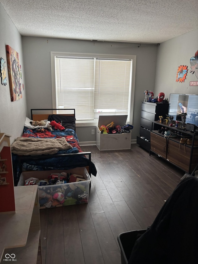 bedroom featuring dark hardwood / wood-style floors and a textured ceiling