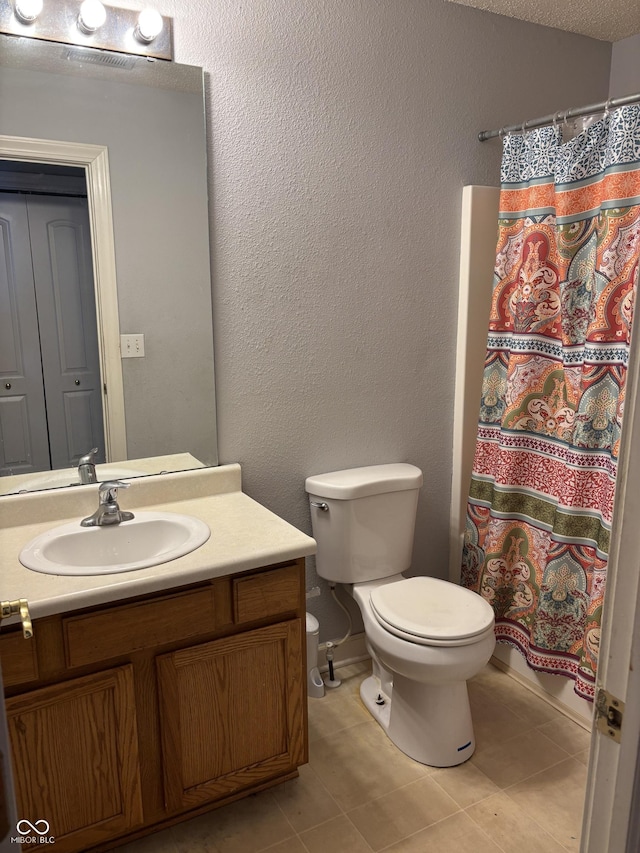 bathroom with tile patterned flooring, vanity, toilet, and a shower with shower curtain