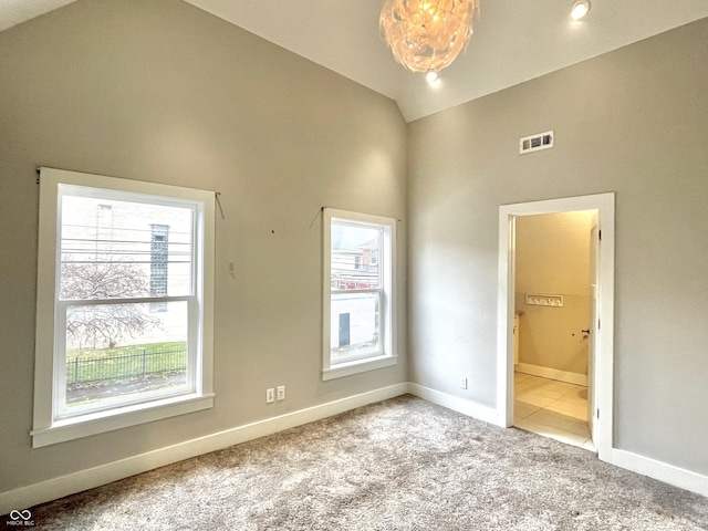 interior space with light colored carpet and high vaulted ceiling