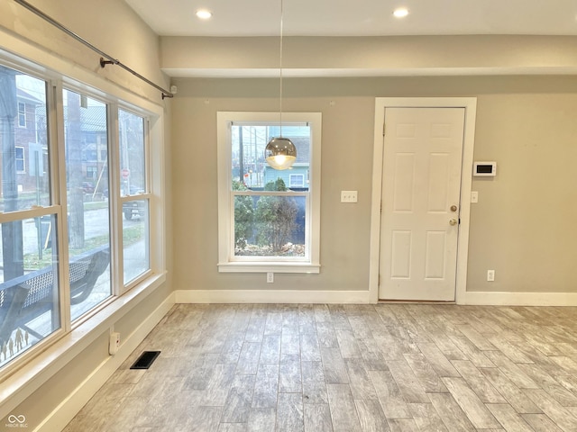 unfurnished dining area with light hardwood / wood-style floors