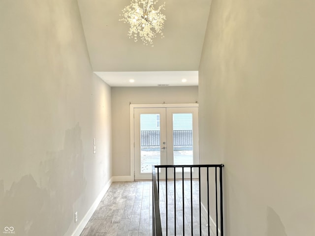 corridor featuring hardwood / wood-style floors and french doors