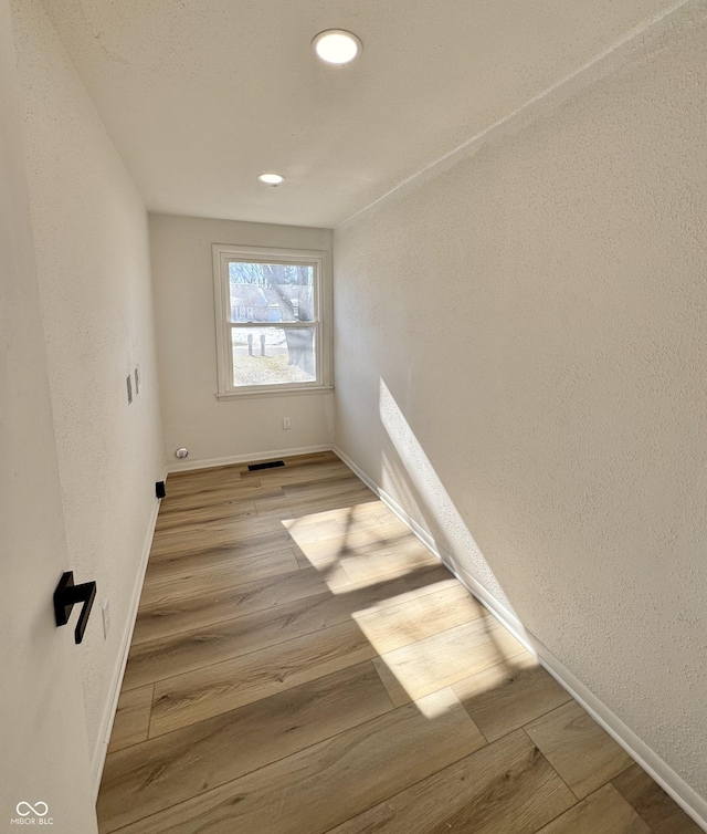 spare room featuring light wood-type flooring