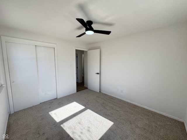 unfurnished bedroom with a closet, ceiling fan, and carpet flooring