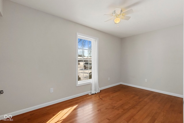 spare room featuring hardwood / wood-style floors and ceiling fan