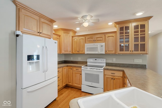 kitchen with ceiling fan, white appliances, and light brown cabinetry