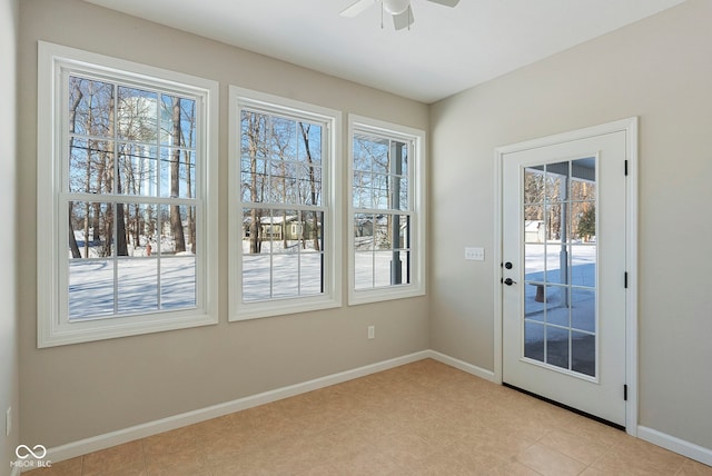 doorway to outside featuring ceiling fan and light tile patterned flooring